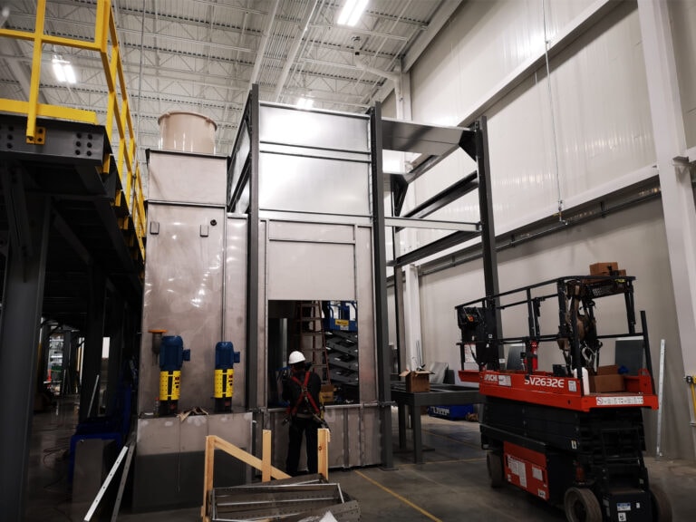 System construction — exterior booth structure with worker