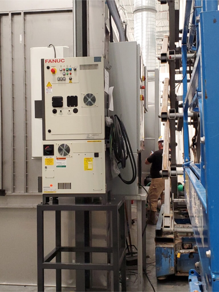 System construction — FANUC control panel being installed