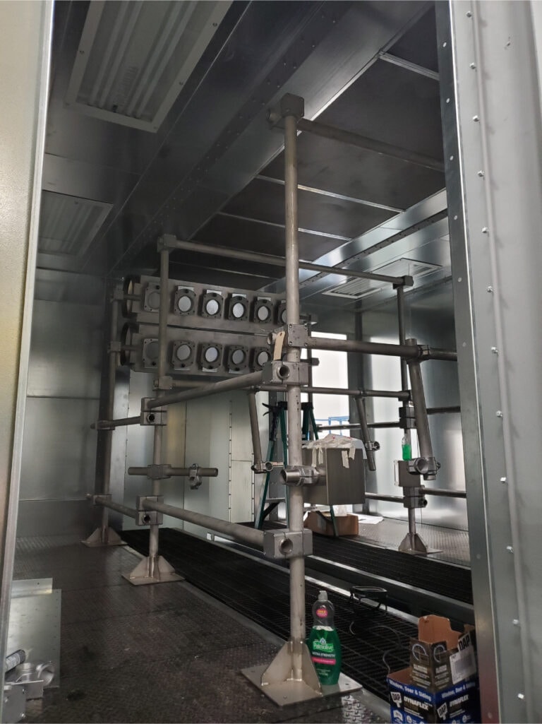 System construction — booth interior with part fixture racks