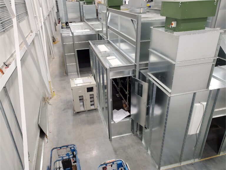 System construction — overhead view of UV booth sections being assembled