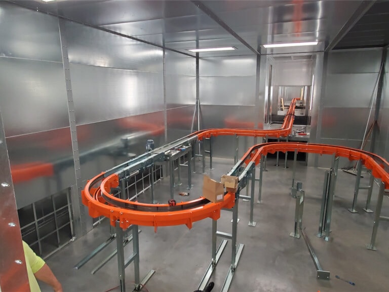 System construction — conveyor track layout from elevated angle