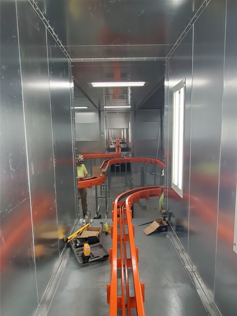 System construction — conveyor track installation detail view