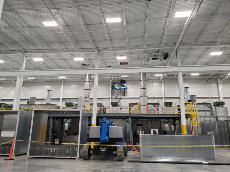 System construction — boom lift and spray booths under construction