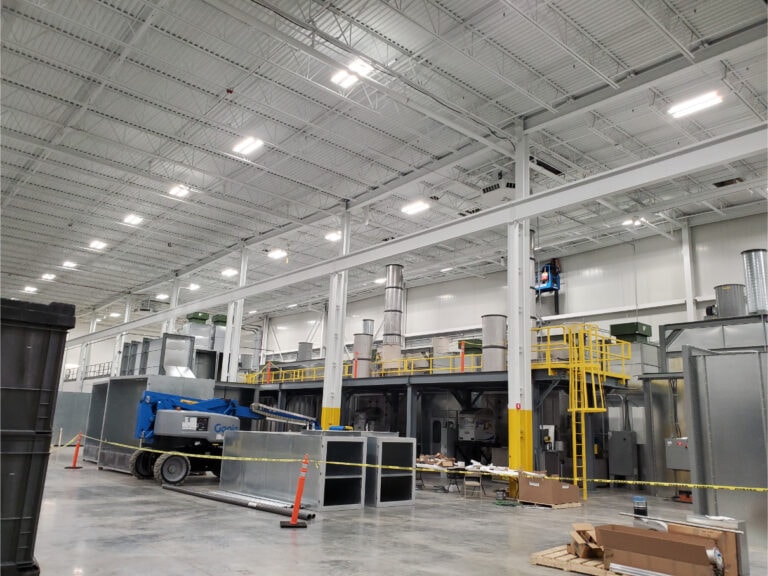 System construction — full facility view with mezzanine and exhaust stacks