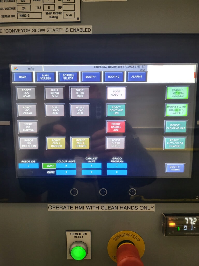 System construction — Omron HMI showing robot and spray gun control screen